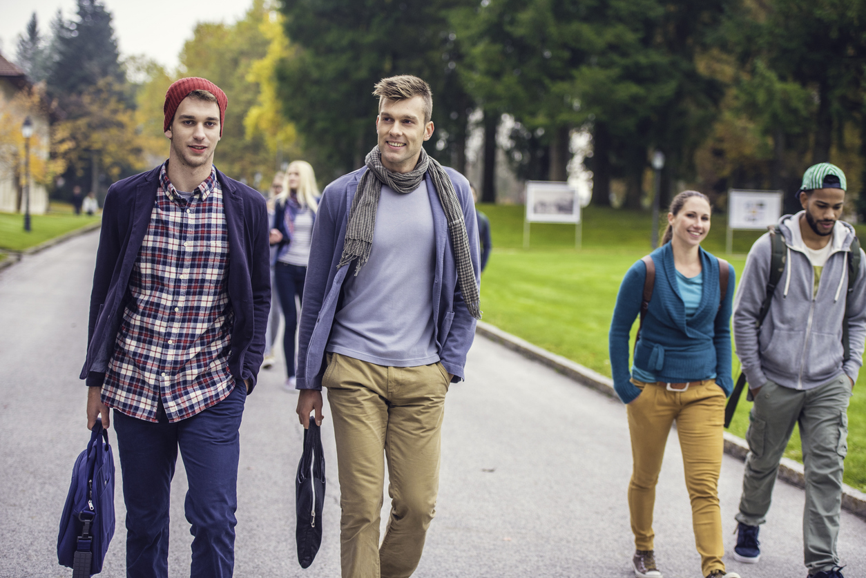 Group of students moving through the park in campus.